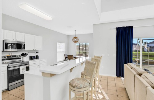 Cumbrian Lakes House | Tropical villa overlooking the lake with a private pool, spa, grill, & AC