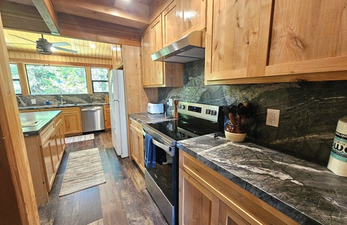 Sierra Cedars Cabin | Tucked in the trees, Cedar Hill is a cozy A-frame cabin with modern updates, a spacious kitchen, wraparound deck, and stunning views. The perfect mountain escape for families, couples, and friends—plus, it's pet-friendly!