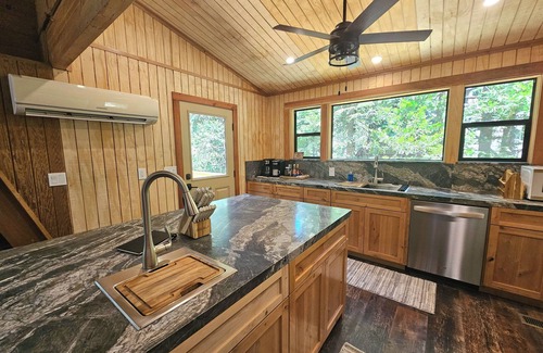 Sierra Cedars Cabin | Tucked in the trees, Cedar Hill is a cozy A-frame cabin with modern updates, a spacious kitchen, wraparound deck, and stunning views. The perfect mountain escape for families, couples, and friends—plus, it's pet-friendly!