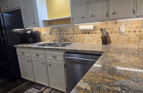 Bryan House | Two-bedroom townhome in a quiet neighborhood with private parking and Wi-Fi.