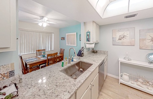 Pine Island Center House | Two-story townhouse with a sunroom, heated pool, hot tub, & tennis courts