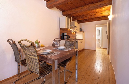 Altstadt Apartment | under a historical exposed wooden beam ceiling, monument protection