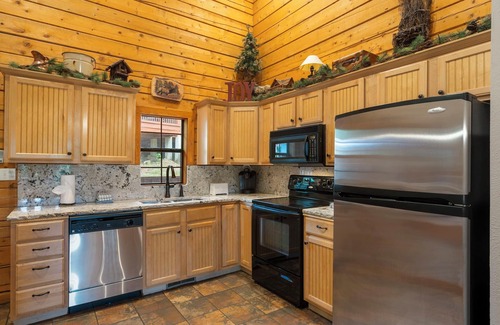 Branson Theater District Cabin | Unwind and Relax! Walk-in Log Cabin with Gas Fireplace and Screened Balcony