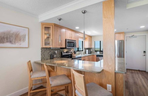 New Smyrna Beach Condo | Updated direct oceanfront corner condo with large wrap-around balcony and heated pool