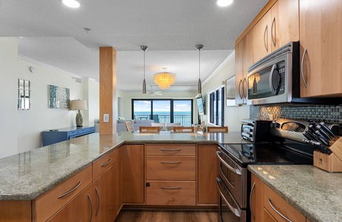 New Smyrna Beach Condo | Updated direct oceanfront corner condo with large wrap-around balcony and heated pool