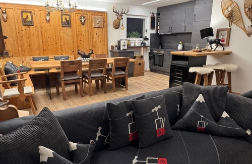 Engadin Scoul House | Vacation home with wellness area in alpine chic retro style