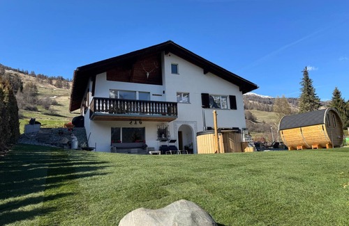 Engadin Scoul House | Vacation home with wellness area in alpine chic retro style