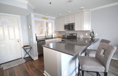 Boyne City Condo | Vaulted Ceilings + Prime Lake Charlevoix Views | Fireplace | Private Patio|