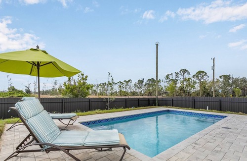 Jacarandas Villa | Villa Del Sol Vacation Pool home with outdoor TV and work/office room.
