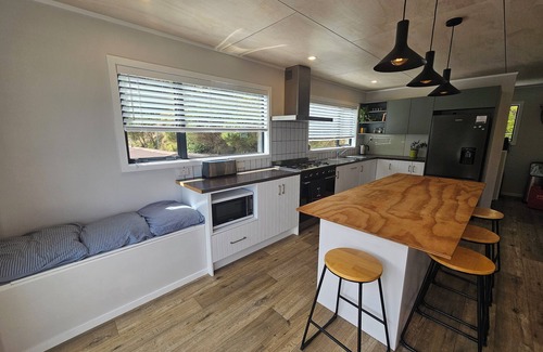 Kereta House | Waikawau Retreat. Private home, overlooking the sea, covered deck to entertain.