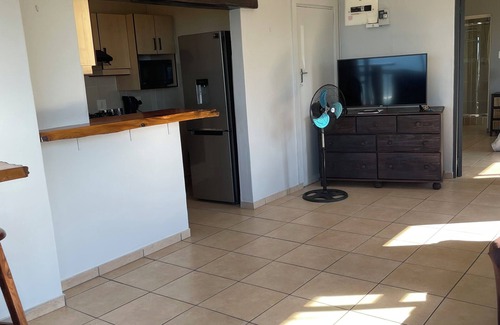 Warner Beach Cottage | Wake up to gorgeous sunrises and sea views upon a wooden balcony.