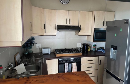 Warner Beach Cottage | Wake up to gorgeous sunrises and sea views upon a wooden balcony.