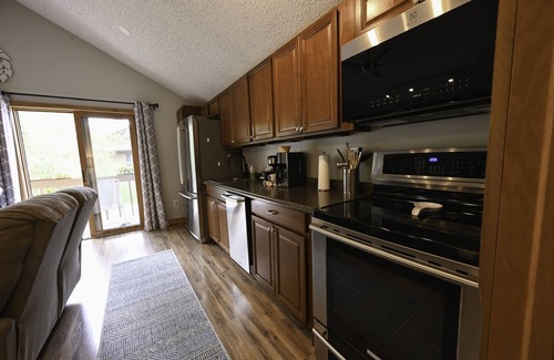 Mancelona Condo | Walk to golf course and pool. fireplace. Sleeps 2 adults. Boat Parking