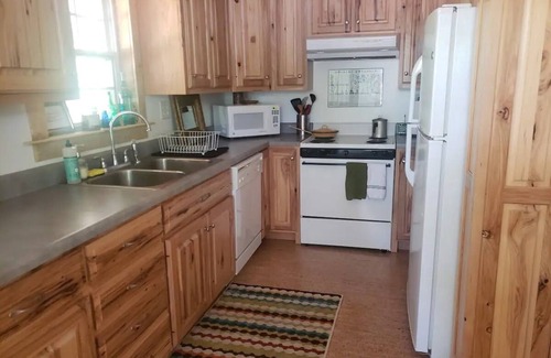 Blountsville Cabin | Watch the birds on a wrap-around porch. Very private and pet friendly.