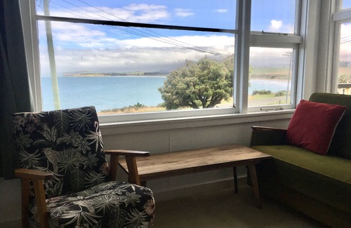 Kakanui House | Watch the weather roll in along the coast with sea views from every room.
