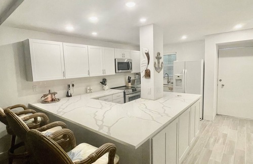 Isles of Capri Condo | WATERFONT Direct Gulf Access with Boat Slip and Covered Parking Spot
