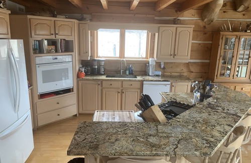 North Algona Wilberforce Cottage | Waterfront log home on Lake Dore. Decks, dock, outdoor hot tub and fire pit.
