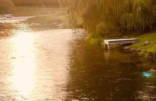 Lanark House | Waterfront modern cottage with hot tub, swimming and fishing right on river