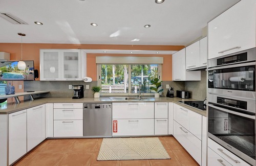 Coral Ridge Isles House | Waterfront Serenity. Pool & BBQ. Koi Pond