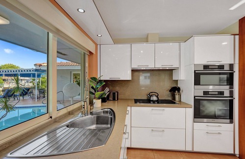 Coral Ridge Isles House | Waterfront Serenity. Pool & BBQ. Koi Pond