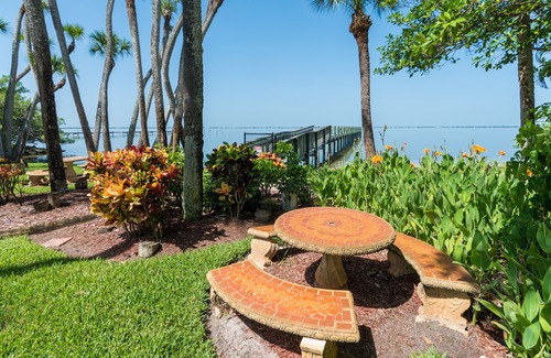 Port Canaveral House | Waterfront Sunsets overlooking a serene garden and a private pier