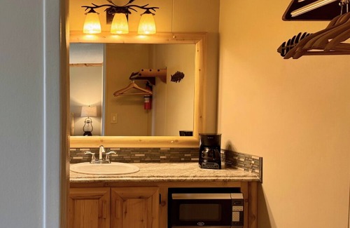 Trout Lake Hotel | Welcoming King Room #6 with AC at lakefront Twin Cedars Resort in Trout Lake MI