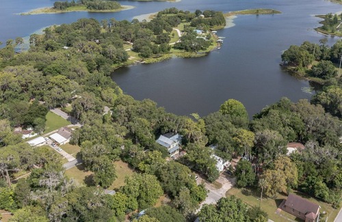 Crescent City House | West Stella Lake House with Outdoor Pool Table & Fireplace by RedAwning