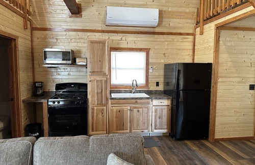 Johnson County Cabin | White cabin in the woods close to Univ. of Central Missouri and Whiteman AF Base