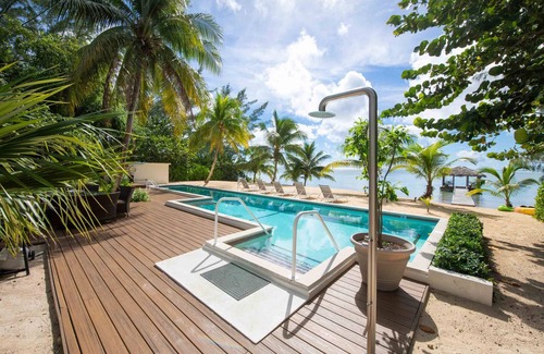 Breakers Villa | White Cottage: Deluxe Oceanfront Home w/Backyard Beachfront, Private Pool, Dock + Free Kayak