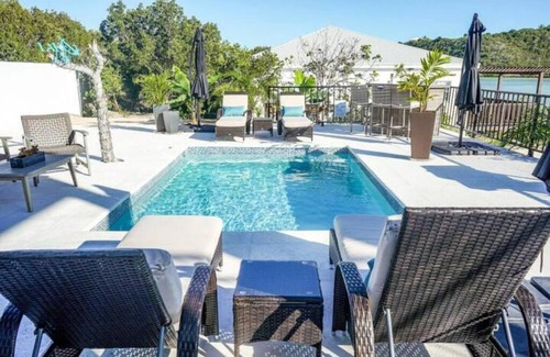 Venetian Road Settlement Villa | White Modern Flamingo Lake Villa