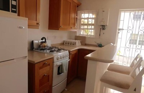 Blue Waters Hotel | Your Home Away from Home by Rockley Beach; Pool, Gardens & Full Kitchen