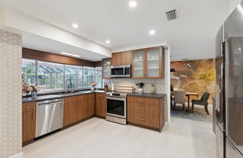 Venetian Way House | Your Ultimate Coastal Retreat! Stunning 4-Bed Canal-Front Home w/Pool & Lanai