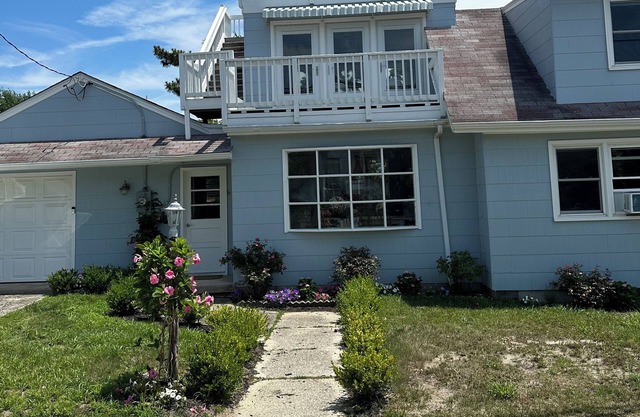 A quaint little beach house located just one block from the beach path.