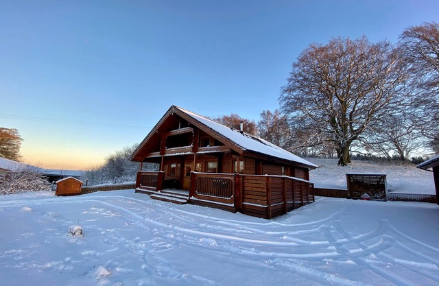 A traditional Scandinavian style lodge, with stylish wooden interior decorated with a Scottish theme