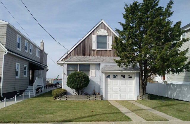 ADORABLE bay front cottage is tucked away on a quiet street with amazing SUNSET VIEWS