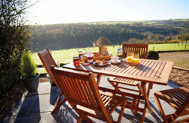 An open plan cottage with a private patio with views of the countryside.
