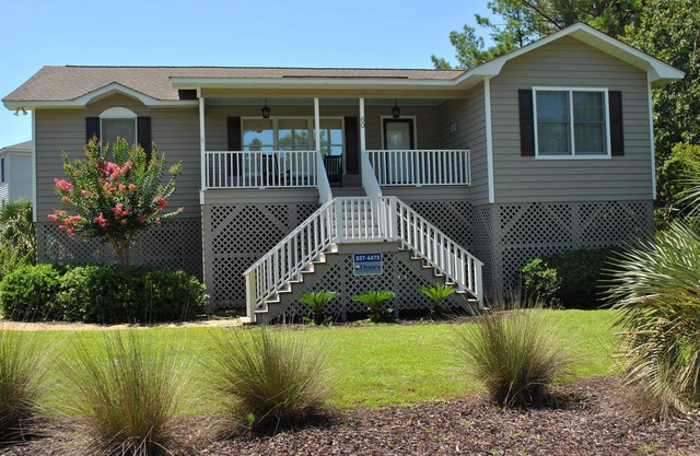 Beach house featuring screen porch with rockers & swing located at North Litchfield Beach.