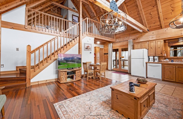 Beautiful cabin nestled among the trees, featuring a loft and relaxing hot tub.