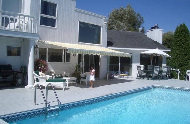 Beautiful, dog-friendly 4BR home on 1.6 acres. Waterfront view and private dock.