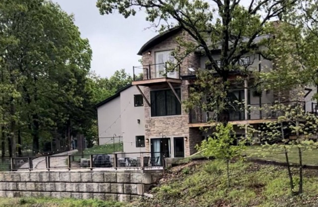 Beautiful Modern mountain getaway overlooking water with fountain.