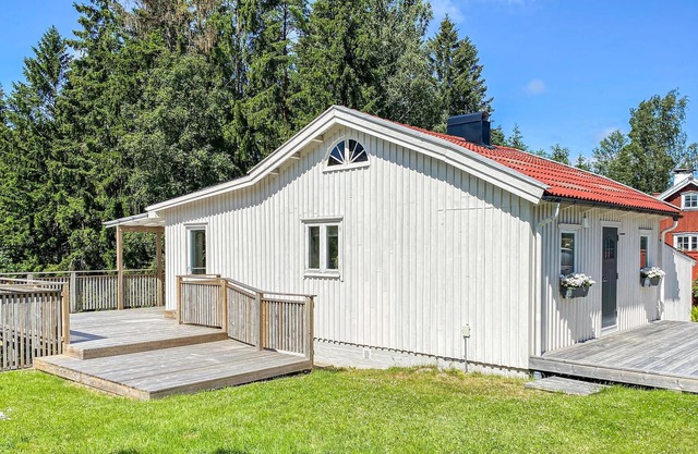 Beautiful wooden house with large wooden terrace in wonderful nature.