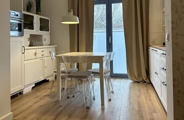 Bright apartment with a small, functional kitchen and a spacious dining area.