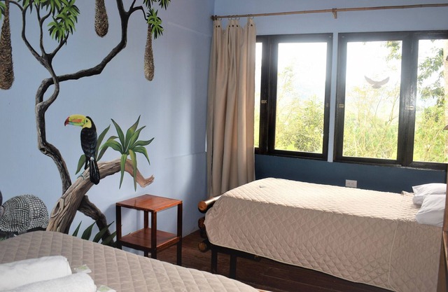 bungalow surrounded by wildlife, gardens, waterfalls and trails.