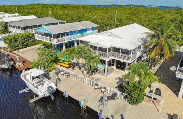 Canal-front home with private dock, hot tub, water views, kayaks, & deck