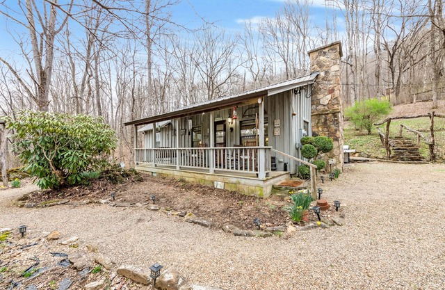 Charming acreage with a grill, W/D, large porch, and wood-burning fireplace