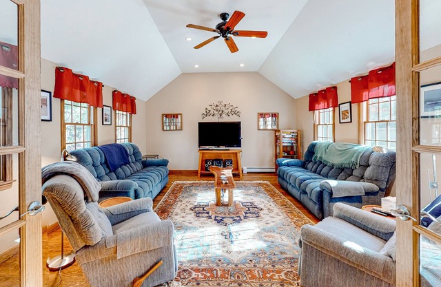 Charming cape-style home with an outdoor shower, wood-burning fireplace, & deck