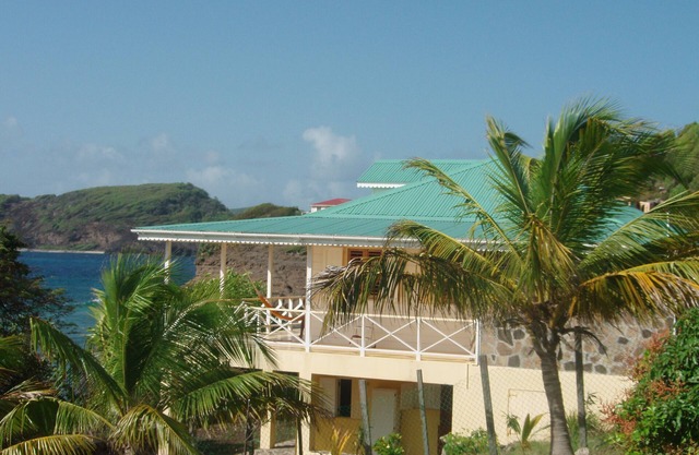 Charming seaside villa with wraparound veranda, ocean views and wind.