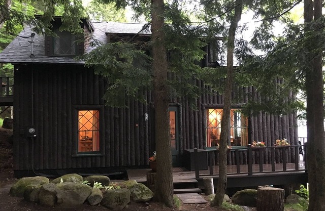 Classic Dryland ADK Boathouse On The Shore Of Long Lake