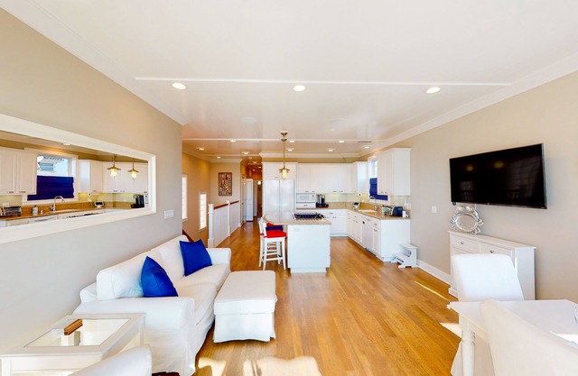 Coastal-themed beachfront home with water views, grill, & beach access