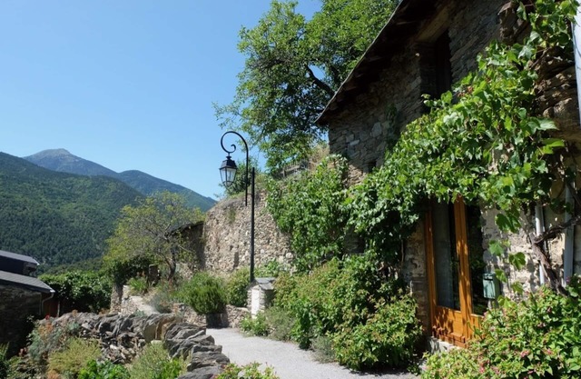 Cottage built into rock face, with spectacular mountain views of the Pyrenees